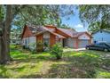 Charming single-Gathering home featuring a well-maintained lawn and mature trees at 4720 Wildflower Dr Dr, Lakeland, FL 33811