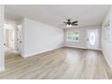 Bright living room features new floors, fresh paint, a ceiling fan, and lots of natural light at 508 Boger N Blvd, Lakeland, FL 33803