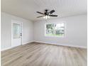 Inviting living room features new floors, fresh paint, a ceiling fan, and lots of natural light at 508 Boger N Blvd, Lakeland, FL 33803