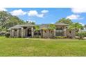 Beautiful home with lush landscaping, mature palms, and manicured lawn at 5819 Hollyhock Dr, Lakeland, FL 33813