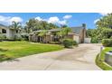 Beautiful home on a large lot with lush landscaping and an expansive driveway at 5819 Hollyhock Dr, Lakeland, FL 33813