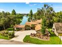 Expansive lakefront property boasting lush greenery, mature trees and a beautiful residence at 6033 Mountain Lake Dr, Lakeland, FL 33813