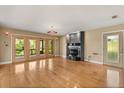 Spacious living room featuring hardwood floors, a cozy fireplace, and natural light at 6033 Mountain Lake Dr, Lakeland, FL 33813