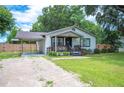 Charming single story home with well-manicured lawn and a covered carport at 615 N Church Ave, Fort Meade, FL 33841
