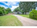 Charming single story home with well-manicured lawn and long driveway at 615 N Church Ave, Fort Meade, FL 33841