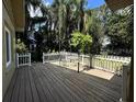 Inviting wooden deck with a white picket fence, perfect for outdoor dining and relaxation at 645 Avenue A Ne, Winter Haven, FL 33881
