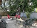 Cozy backyard fire pit area with ample seating and mature trees surrounding the space at 645 Avenue A Ne, Winter Haven, FL 33881