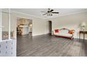 Open living room featuring wood floors, seamlessly connecting to the kitchen at 686 22Nd Nw St, Winter Haven, FL 33880