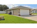 The exterior of the house has a large two car garage and a well manicured lawn at 8219 Rangers Path, Lakeland, FL 33809
