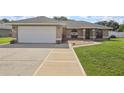 Inviting single-story home with a spacious two-car garage and attractive landscaping at 8219 Rangers Path, Lakeland, FL 33809