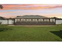 Enclosed sunroom with a wall of windows overlooking the lush green lawn at 8219 Rangers Path, Lakeland, FL 33809