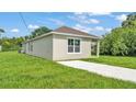 This freshly painted home offers a neat exterior, complemented by a well-maintained green lawn at 1025 Lakewood Ct, Lakeland, FL 33801