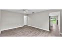 Spacious living room with modern floors, light-colored walls, and a ceiling fan at 1025 Lakewood Ct, Lakeland, FL 33801