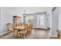 Formal dining room with elegant chandelier, wood floors, and seating for eight at 2472 Tahoe Dr, Lakeland, FL 33805
