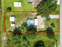 Expansive property with a pool, storage sheds, and lush greenery at 2700 Park Ave, Indian Lake Estates, FL 33855