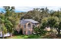 Beautiful two-story brick home nestled among mature trees, offering a private and serene setting at 351 Crystal Ridge Way, Lake Mary, FL 32746