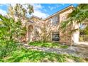 Inviting brick home with lush landscaping and a covered entrance, perfect for relaxing at 351 Crystal Ridge Way, Lake Mary, FL 32746