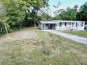 Front yard view of a light gray house at 313 S Ridgewood Ave, Deland, FL 32720