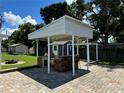 This backyard features an amazing outdoor kitchen with a stone bar, seating, and a built-in grill at 508 Garden N Dr, Lakeland, FL 33813