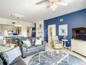 Bright living room with comfy seating, coastal decor, and views of kitchen and dining area at 5300 S Atlantic Ave # 6-505, New Smyrna Beach, FL 32169