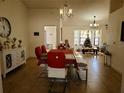 Bright dining room featuring modern furniture, tiled floors, and elegant chandelier lighting at 1470 Ne Old Mill Dr, Deltona, FL 32725