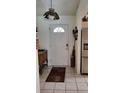 Inviting entryway featuring a tiled floor, decorative lighting, and a charming wooden accent table at 806 South St, New Smyrna Beach, Fl 32168, FL 32168