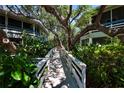 A welcoming walkway leads to the building, surrounded by lush greenery and providing a tranquil entrance at 4303 Sea Mist Dr # 225, New Smyrna Beach, FL 32169