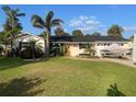 Lovely single-story home with a lush lawn, tropical plants, and a driveway with room for boat parking at 4606 Doris Dr, New Smyrna Beach, FL 32169