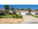 Inviting single-story home with an attached garage and well-maintained landscaping on a sunny day at 4606 Doris Dr, New Smyrna Beach, FL 32169