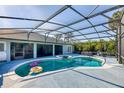 Inviting pool area with covered patio and lush landscaping at 756 Bay Dr, New Smyrna Beach, FL 32168