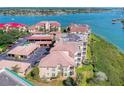 Aerial view of waterfront condo building with parking and boat slips at 434 Bouchelle Dr # 304, New Smyrna Beach, FL 32169