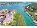 Aerial view of waterfront condo building near bridge and waterway at 434 Bouchelle Dr # 304, New Smyrna Beach, FL 32169