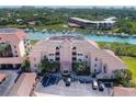 Aerial view of waterfront condo building with parking and boat slips at 434 Bouchelle Dr # 304, New Smyrna Beach, FL 32169