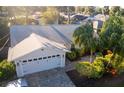 Charming exterior of the home, featuring a brick driveway, a two-car garage, manicured landscaping, and a sunny atmosphere at 1312 2Nd St, Edgewater, FL 32132
