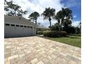 Two-car garage, paver driveway and landscaped yard at 1312 2Nd St, Edgewater, FL 32132