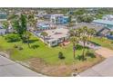Single story home with a well manicured lawn and a pool in the backyard, surrounded by mature palms at 327 Due East St, New Smyrna Beach, FL 32169