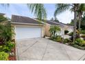 Tan stucco building with white garages and tropical landscaping at 2290 Hawks Cove Cir, New Smyrna Beach, FL 32168