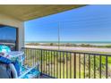 Inviting balcony view with seating offering a serene ocean backdrop, and overlooking the beach at 3180 Ocean Shore Blvd # 208, Ormond Beach, FL 32176