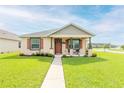 Charming single-Gathering home showcasing a neat lawn, a welcoming walkway, and a delightful front porch at 3365 Meleto Blvd, New Smyrna Beach, FL 32168