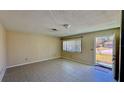 Bright living room with tiled floor, large window and neutral paint at 1119 Edith Dr, Daytona Beach, FL 32117