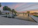 Luxury pool with sunset view, loungers, and fire pit at 1194 N Peninsula Ave, New Smyrna Beach, FL 32169