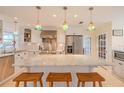 Bright kitchen features a marble top island, stainless steel appliances, and colorful pendant lighting at 1949 Bayview Dr, New Smyrna Beach, FL 32168