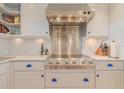 A stainless steel oven and hood is featured in this kitchen with marble countertops at 1949 Bayview Dr, New Smyrna Beach, FL 32168