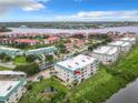 Scenic aerial view of waterfront condos with lush landscaping and serene water views on a sunny day at 426 Bouchelle Dr # 303, New Smyrna Beach, FL 32169