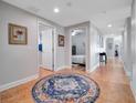 Inviting hallway with neutral walls and a decorative rug leading to various rooms within the home at 701 N Atlantic Ave # 202, New Smyrna Beach, FL 32169