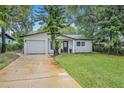 Newly renovated home with a modern facade and well-manicured lawn at 798 E 11Th Ave, New Smyrna Beach, FL 32169