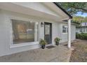 Charming front entrance with a black door and updated porch at 798 E 11Th Ave, New Smyrna Beach, FL 32169