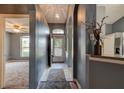 Inviting entryway featuring tile flooring, gray walls, archways, and decorative lighting at 1277 Harms Way, Port Orange, FL 32129