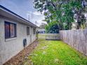 Fenced backyard with grassy area and wooden shed at 628 10Th St, Daytona Beach, FL 32117