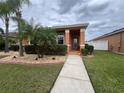 Inviting single-story home with a well-manicured lawn and pathway to the front door at 3325 Pintello Ave, New Smyrna Beach, FL 32168
